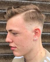 Josh Cooper Model Skin Fade with a hard parting. Slightly textured top then blow dried into a quiff 