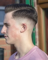Mid skin fade Keeping it classic with a mid skin fade, forced parting and a clean quiff on top.
